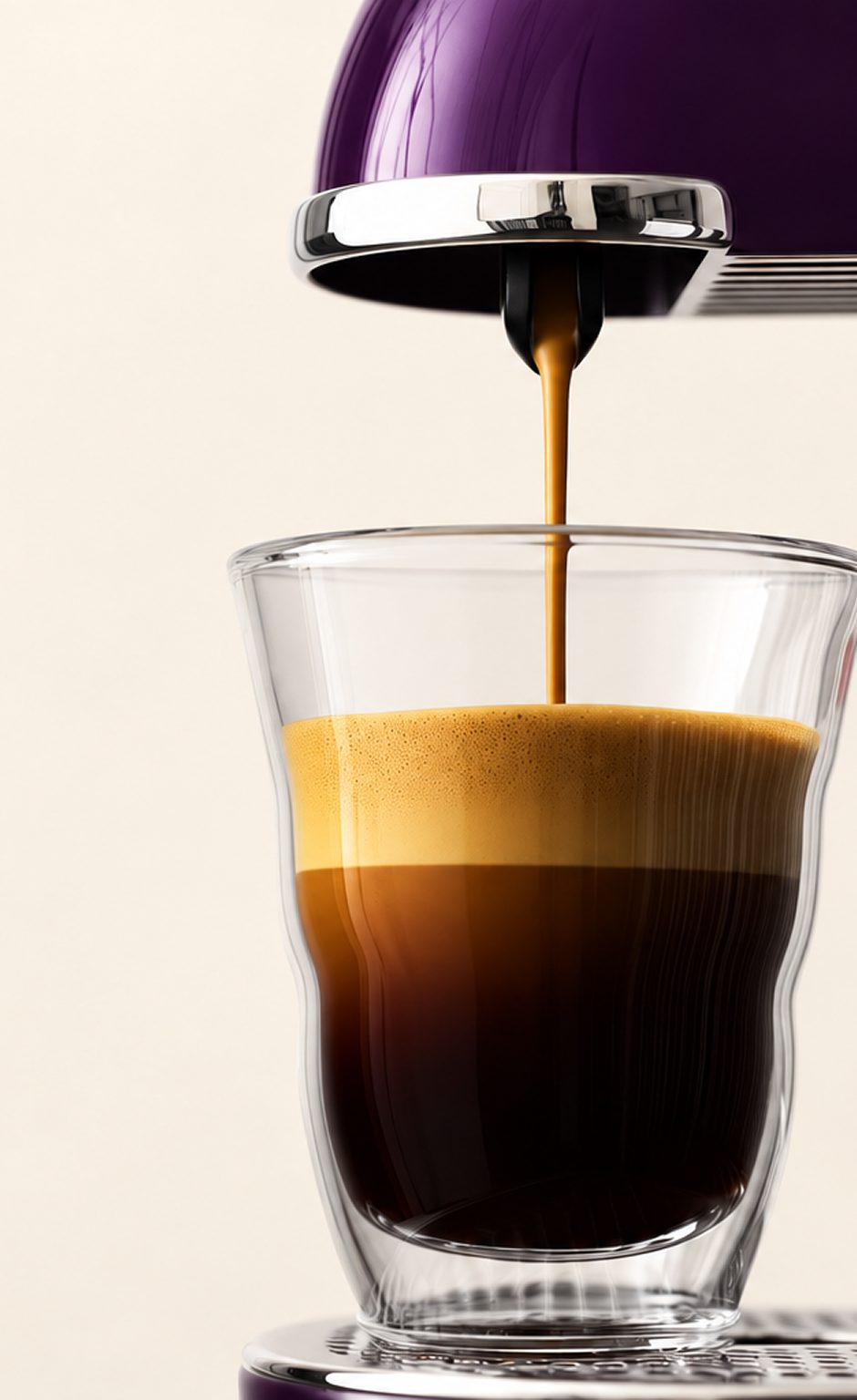 Un espresso et sa mousse dans un verre double paroi, sous une machine à capsules violette